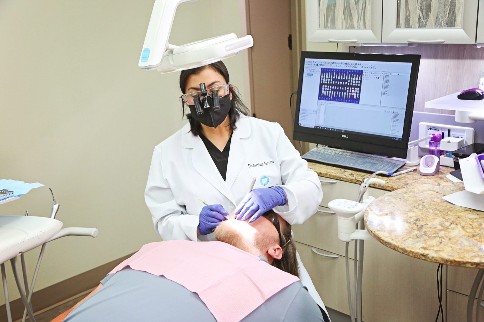 Dr. Mariam Hanna examining a patient at Tulsa Modern Dental