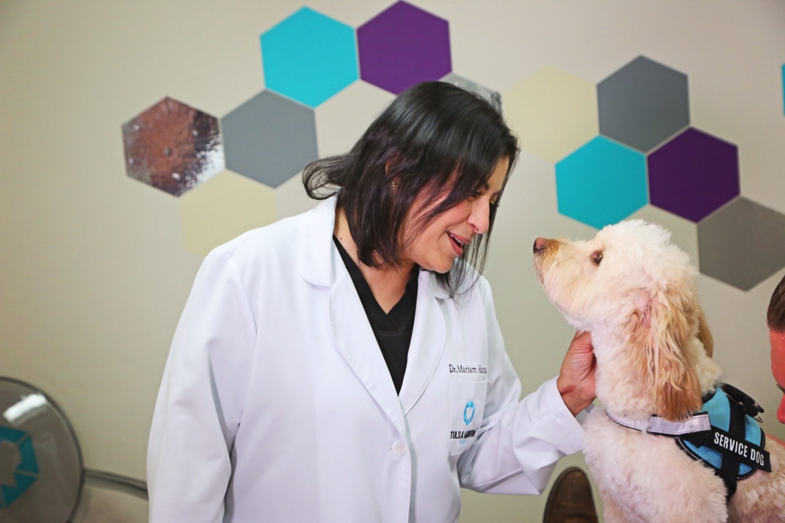 Dr. Mariam Hanna with a patient's service dog at Tulsa Modern Dental